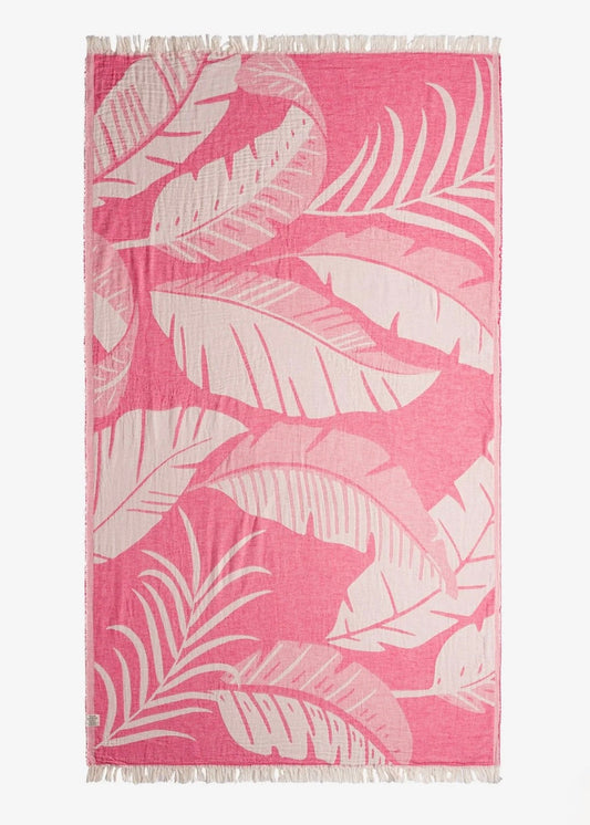 Pink and white leaf patterned towel on a white background